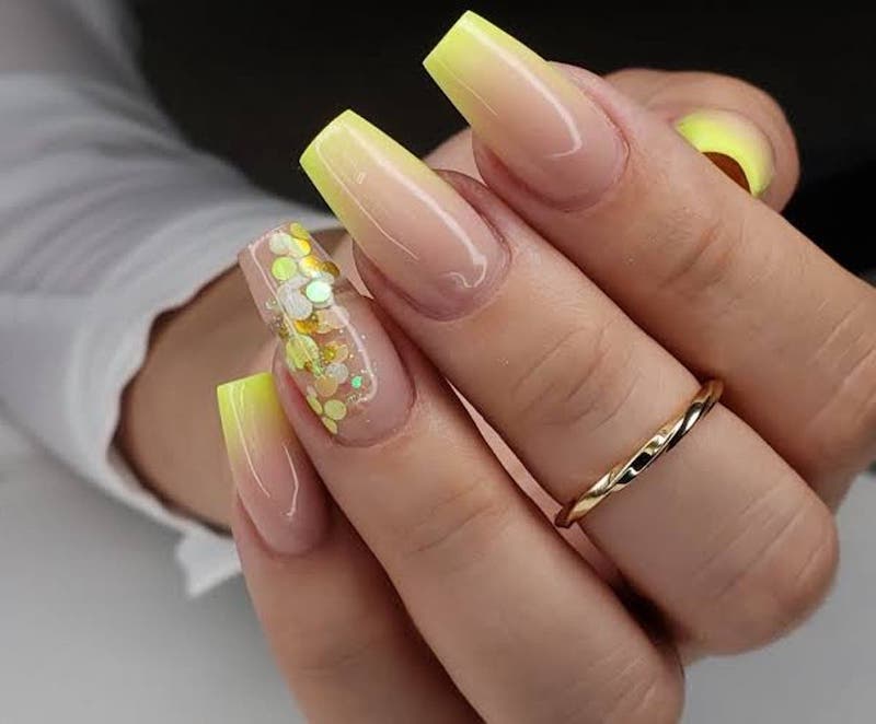 manicure with yellow and glitter nail polish